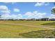 Expansive golf course view with lush green grass and blue skies at 13067 Woodford St, Orlando, FL 32832