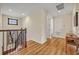 Upstairs hallway with wood flooring and a classic staircase design with a small window at 13067 Woodford St, Orlando, FL 32832