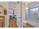 This interior view shows bathroom with shower and toilet and a bedroom with desk and cozy bed beyond an open door at 13067 Woodford St, Orlando, FL 32832