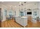Bright kitchen features a white center island with a view into the breakfast nook and living room at 13067 Woodford St, Orlando, FL 32832