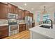 Bright kitchen with stainless steel appliances, a center island, and a breakfast nook at 13067 Woodford St, Orlando, FL 32832