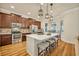 Bright kitchen features a center island with a white countertop, pendant lights, stainless appliances, and a breakfast nook at 13067 Woodford St, Orlando, FL 32832