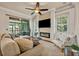 Cozy living room with fireplace and sliding glass doors to outdoor space at 13067 Woodford St, Orlando, FL 32832
