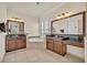 Luxurious main bathroom with dual vanities, a soaking tub, and elegant mirrors at 13067 Woodford St, Orlando, FL 32832