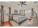 Spacious main bedroom features elegant details, tray ceilings, hardwood floors, and ample natural light at 13067 Woodford St, Orlando, FL 32832