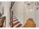 A carpeted staircase with decorative wrought iron spindles and stained wood trim details at 13067 Woodford St, Orlando, FL 32832