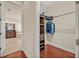A walk-in closet with custom wood shelving and drawers is located just off the main bathroom at 13067 Woodford St, Orlando, FL 32832