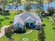 An impressive aerial view showcases the property's large lot, lush landscaping, and a view of the pond at 14208 Bella Ln, Orlando, FL 32832