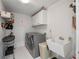 Well-equipped laundry room with modern washer and dryer, sink, and ample storage at 14208 Bella Ln, Orlando, FL 32832