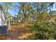 The backyard features natural foliage, trees, and outdoor access to multiple residential buildings at 144 E Plantation Blvd, Lake Mary, FL 32746