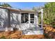Home's rear exterior features a small deck, stairs, and exterior access at 144 E Plantation Blvd, Lake Mary, FL 32746