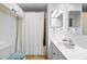 This bathroom features a shower and tub combo with a white curtain and a mirrored vanity at 144 E Plantation Blvd, Lake Mary, FL 32746