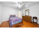 Bedroom with wood floors, bright light fixture, and warm inviting colors at 144 E Plantation Blvd, Lake Mary, FL 32746