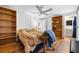 Bedroom with hardwood floors, built-in shelving, and ensuite bathroom at 144 E Plantation Blvd, Lake Mary, FL 32746