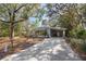 Welcoming single-story home with covered parking area and natural surroundings at 144 E Plantation Blvd, Lake Mary, FL 32746