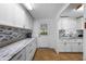 Well-lit kitchen featuring granite countertops, mosaic backsplash and a convenient door to outside at 144 E Plantation Blvd, Lake Mary, FL 32746