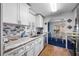 Kitchen includes granite counters, ample cabinets, stainless steel appliances and a view to the dining area at 144 E Plantation Blvd, Lake Mary, FL 32746
