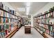Well-stocked library with many bookshelves filled with books and interior lighting at 144 E Plantation Blvd, Lake Mary, FL 32746