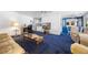 Open living room with plush blue carpet, light walls, and an open floor plan at 144 E Plantation Blvd, Lake Mary, FL 32746