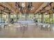 Large meeting room featuring high ceilings, ceiling fans, a disco ball, stage, and floor to ceiling windows at 144 E Plantation Blvd, Lake Mary, FL 32746