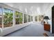 Bright sunroom with large windows, neutral carpeting, and access to the outdoors at 144 E Plantation Blvd, Lake Mary, FL 32746