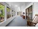 Bright sunroom with carpet floors, floor-to-ceiling windows, and a slider door offering plenty of light and access at 144 E Plantation Blvd, Lake Mary, FL 32746