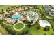 Aerial view showcasing the community's pools, amenity center, beach volleyball and lush landscaping at 1445 Rolling Fairway Dr, Davenport, FL 33896