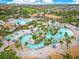 Aerial view showcasing the community's many pools, amenity center, and lush landscaping at 1445 Rolling Fairway Dr, Davenport, FL 33896
