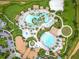 Aerial view showcasing the community's many pools, amenity center, and lush landscaping at 1445 Rolling Fairway Dr, Davenport, FL 33896