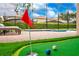 Backyard featuring a custom putting green and view of the pool at 1445 Rolling Fairway Dr, Davenport, FL 33896
