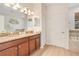 Bathroom with double sink vanity, granite countertops, and a separate soaking tub at 1445 Rolling Fairway Dr, Davenport, FL 33896