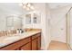 Elegant bathroom featuring a double vanity, granite countertops, and a glass-enclosed shower, offering a luxurious retreat at 1445 Rolling Fairway Dr, Davenport, FL 33896