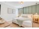 Beautiful bedroom with a green accent wall, stylish decor, and ample natural light, creating a serene and inviting space at 1445 Rolling Fairway Dr, Davenport, FL 33896
