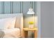 Close-up highlighting the bedside table with stylish lamp, plant, and decor, adding a touch of elegance to the bedroom at 1445 Rolling Fairway Dr, Davenport, FL 33896