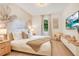 A serene bedroom with a palm mural, neutral decor, and a window with natural light at 1445 Rolling Fairway Dr, Davenport, FL 33896