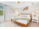 Charming bedroom with a woven headboard, stylish wall art, and soft lighting, creating a cozy and inviting atmosphere at 1445 Rolling Fairway Dr, Davenport, FL 33896