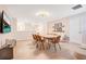 Spacious dining room with large table, seating for eight, and a modern light fixture at 1445 Rolling Fairway Dr, Davenport, FL 33896