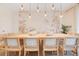 Elegant dining room with seating for twelve, modern lighting, and a floral accent wall at 1445 Rolling Fairway Dr, Davenport, FL 33896