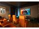 A cozy home theater featuring comfortable seating and a large screen displaying 'Harry Potter' movie at 1445 Rolling Fairway Dr, Davenport, FL 33896