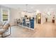 Modern kitchen with white cabinetry, stainless steel appliances, and seating at the island at 1445 Rolling Fairway Dr, Davenport, FL 33896