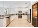 Modern kitchen featuring stainless steel appliances, granite countertops, and a built in wine cooler at 1445 Rolling Fairway Dr, Davenport, FL 33896