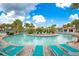 Resort-style lazy river with palm trees and lounge chairs at 1445 Rolling Fairway Dr, Davenport, FL 33896