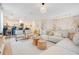 Open-concept living space with an oversized sectional, and views into dining and kitchen areas at 1445 Rolling Fairway Dr, Davenport, FL 33896