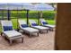 Patio with lounge chairs and blue pillows at 1445 Rolling Fairway Dr, Davenport, FL 33896
