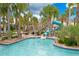 Community pool featuring a water slide and palm trees at 1445 Rolling Fairway Dr, Davenport, FL 33896