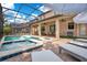 Backyard pool and spa with lounge chairs, patio seating, and enclosed screen at 1445 Rolling Fairway Dr, Davenport, FL 33896