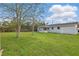 Spacious backyard featuring a lush lawn, mature trees, and a screened in patio at 1612 Eastbrook Blvd, Winter Park, FL 32792