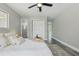 Cozy bedroom featuring neutral tones, plush bedding, and wood-look flooring at 1612 Eastbrook Blvd, Winter Park, FL 32792