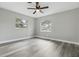 A light-filled room with modern ceiling fan, two windows, and gray wood-look floors at 1612 Eastbrook Blvd, Winter Park, FL 32792