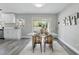 Stylish dining area featuring a modern table, elegant chairs, and sliding glass doors to the screened patio at 1612 Eastbrook Blvd, Winter Park, FL 32792